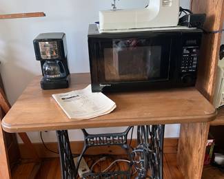 Great mix of vintage and modern household items, perfect for sewing enthusiasts and home use:
Vintage Singer Treadle Sewing Machine Base with Wooden Top – A true antique piece with cast iron base marked SINGER, repurposed with a solid wood top. Ideal for collectors, repurposing as a table, or restoration.
Kenmore Sewing Machine – Compact and functional, with easy-to-use dials and included instruction manual. Perfect for beginner or seasoned sewists.
Magic Chef Microwave – Modern countertop microwave oven with digital display and multiple settings.
Coffee Maker – Small drip-style coffee maker, convenient for everyday brewing.
This collection combines antique craftsmanship with modern convenience—ideal for both collectors and practical household use.