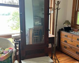 Antique Hall Tree with Marble Seat & Mirror
Elegant antique wooden hall tree featuring a tall beveled mirror, decorative carved details, and original hardware. Includes multiple coat hooks, a small storage drawer, and a white marble seat—a true statement piece that combines beauty and function. Perfect for an entryway or foyer.
Also pictured:
Antique wooden dresser with ornate drawer pulls and marble top
Metal coat rack with multiple hooks
Vintage wicker chair with colorful throw blanket
Each piece offers timeless craftsmanship, adding charm and character to any home.