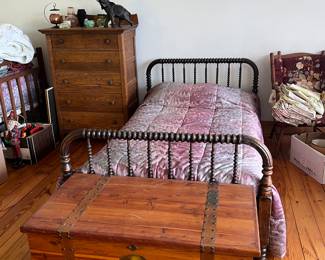 Antique Bedroom Furniture
A beautiful collection of vintage and antique bedroom pieces, including an antique spool bed with turned wood spindles and a rich finish, featuring a classic farmhouse style design.
Vintage cedar chest with metal hardware and a unique decorative decal, perfect for blanket or linen storage.
Tall wooden chest of drawers with dovetail construction and original hardware, offering plenty of storage.
Additional vintage accents: floral upholstered chair, framed wall art, and assorted linens.
This bedroom set brings timeless charm and character, making it ideal for collectors of antique furniture or those seeking to add warmth and history to their home décor.