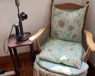 Vintage Wooden Chair & Antique Lamp
Vintage wooden armchair with carved details, spindle back, and original floral-patterned cushions with skirted bottom. A charming piece that would look great in a cottage, farmhouse, or vintage-inspired space.
Antique table lamp with unique design, sitting on a small wooden side table. Lamp features an old-fashioned industrial style and adds character to any room.
A lovely corner set perfect for collectors of vintage furniture and décor or those looking for one-of-a-kind statement pieces.