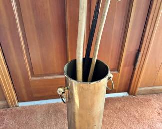 Mid century brass umbrella stand, shown with a collection of canes