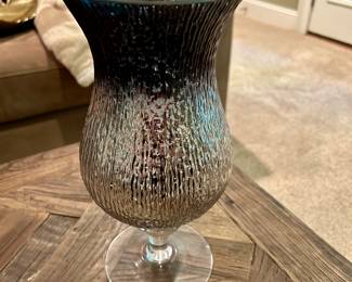 Textured Glass Pedestal Vase – Silver Interior - $15
Beautiful mid-century style vase with clear textured glass and a reflective silver interior. About 12″ tall. Adds a sleek, modern touch to any room. Small chip on the side.