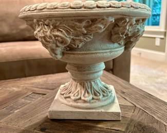 Ornate Pedestal Urn - $12
Classic decorative urn with an antique white finish, detailed scrollwork, and ram’s head motif. Made of composite stone/resin for a substantial look and weight. Perfect as a centerpiece, accent piece, or planter.

Dimensions (approx.): 10” tall × 9” wide
Condition: Excellent