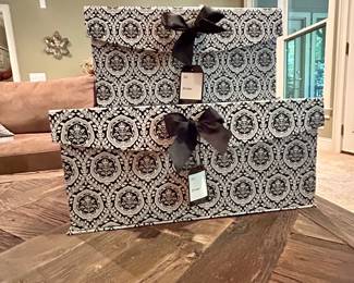 Set of 2 Decorative Storage Boxes - $12 for the Set
Black-and-white patterned decorative storage boxes with satin ribbon bows and gift tags. Sturdy construction with polka dot interior lining. Perfect for organizing, gift-giving, or stylish home storage.

Dimensions (approx.):
	•	Large: 17” × 12” × 8”
	•	Medium: 15” × 10” × 7”

Condition: Excellent