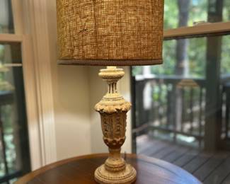Decorative  table lamp with carved base and textured woven shade. $65
The distressed finish and ornate detailing give it a rustic, old-world charm. Fully functional and ready to use, this lamp makes a great accent for a living room, bedroom, or study. 