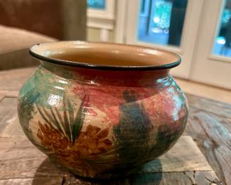 Handmade Studio Pottery Vessel – Signed Haley EC ’98. - $35
This unique artisan piece features a rounded form with a wide mouth and is finished in earthy tones of red, green, and tan with a glossy glaze. Decorative floral and foliage-style designs accent the exterior.