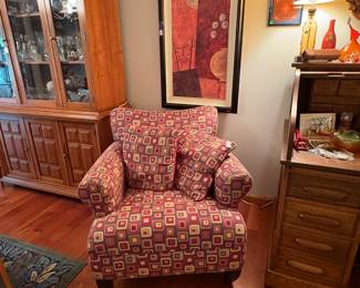 This is a great chair! It is so much colorful fun and VERY comfy. the artwork behind it is a framed oil.