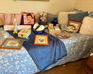 The twin bed has a very nice coverlet and matching blue throw.