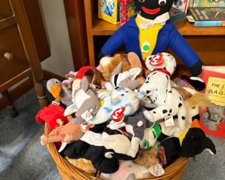 A basket of beanie babies being monitored by British doll, Golliwogg.