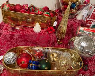 Brass trays of Christmas ornaments.