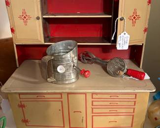 What a great toy! We found this in the garage. It is a child's tin kitchen cupboard. The little sifter and beater and so cute.