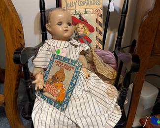 Another antique child's rocker with a composition doll and lovely old books.