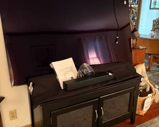 This is the largest and newest of the flat screen televisions. We have it propped up on the entertainment cabinet. It was wall-mounted and we didn't want to try that for the sale!