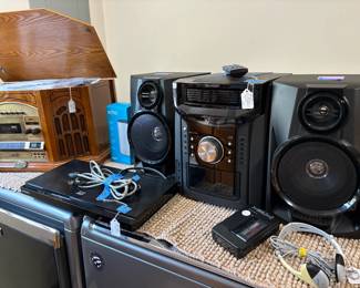 In the background is a Thomas Pacconi new, never used, classic style turntable and AM-FM Radio Cassette CD player model TPC-MSE-800. In the foreground is a Sharp mini component system.