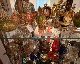 Inside one of the curio cabinets...Joan Rivers decorative eggs and miniature oil lamps.