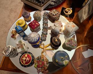 This picture represents a collection of fine little trinket boxes. Some are Limoges.