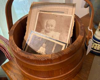Shaker bucket with lid underneath. Containing "instant family" photos. :)