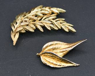 pair of gold tone brooches