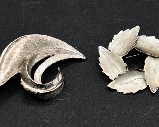 pair of silver tone brooches