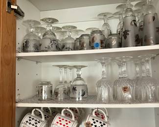 playing card coffee mug set and antique glassware.
