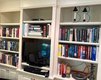 Books, TV, Bose speaker, Sonos system, candle holders, TV and MORE