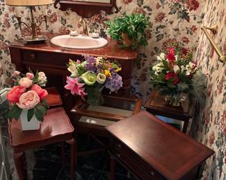 Collection of side tables/chests and shown with floral decor vases