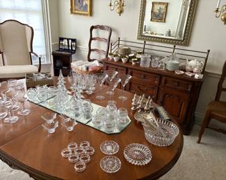 Dining table with 2 additional leaves and pads, Sideboard, ladder backchairs with rush seats and captains chairs, and shown with:  champagne glasses, crystal votives, sterling and Christmas trees
