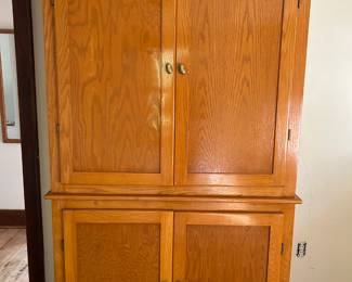 Armoire with drawers below and hanging space above.