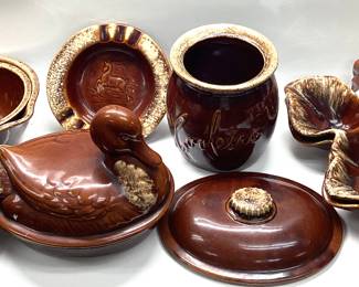 34 PCS HULL POTTERY BROWN DRIP GLAZE 34 PIECES INCLUDING NESTING DUCK, BUTTER DISH, 2 OAK LEAVES, STAG ASHTRAY AND MORE.