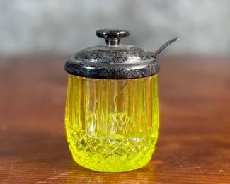 This lot features an antique uranium jar with a Hawkes sterling silver lid and an antique silver spoon. The sterling lid weight is approx. 21.66 grams.
