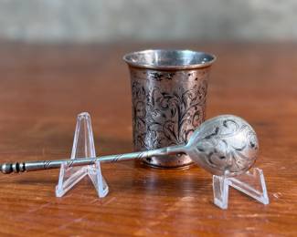 This lot features a pair of antique Russian silver items including a spoon and cup with intricate designs throughout. Both items bear the “84” Russian silver markings with a total approx. weight 87.22 grams.
