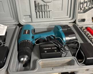 Cordless drill/driver kit with charger, bits, and accessories in a hard carry case. Comes with battery, charging stand, and multiple drill/screwdriver bits. Works well and ready for projects.