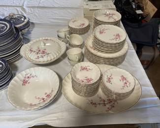 This is a large vintage floral china dinnerware set, decorated with delicate pink blossoms and gold trim. The collection includes dinner plates, salad plates, bowls, cups, saucers, serving bowls, and a lidded covered dish—perfect for complete table settings.