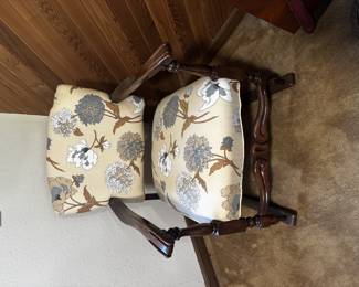 This is a vintage upholstered wooden armchair with carved wood frame and floral patterned fabric. Sturdy construction with classic styling makes it suitable as an accent chair, desk chair, or reading nook piece.