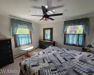 Dresser, mirror, tall dresser, round table, large bed, light, drapes all the trim molding, that floor heater, and of course the ceiling fan as well