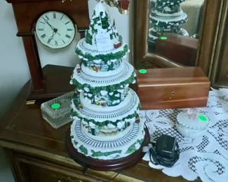 This is a clock along with other items along with a Thomas Kinkade musical Christmas tree.