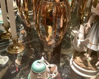 Showing the crystal gold vase and kne of the many Hummel bells.