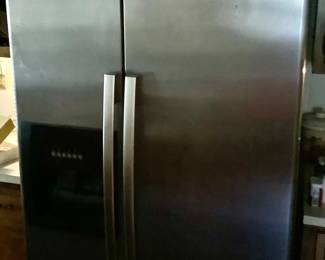 The Whirlpool refrigerator with ice maker, freezer on one side.  Has the ice and water features on the side.  In great shape.