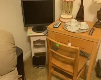 Singer cabinet sewing machine with wood school chair.
