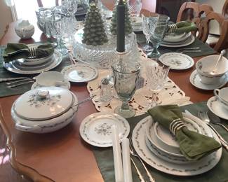 In the middle of the table is a gorgeous, and I mean gorgeous, Waterford cake plate, with green Noritake glasses and Waterford crystal wine/water stems.  The stainless on the table is by Oneida.