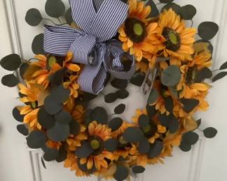 Fall sunflower wreath with bow welcoming you to sale.