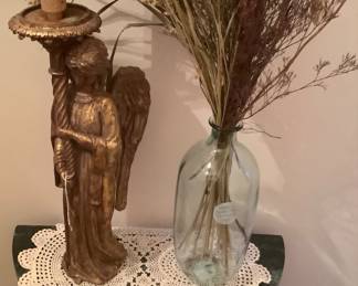 Inside the door is a small table with Angel candle holder and fall foliage.
