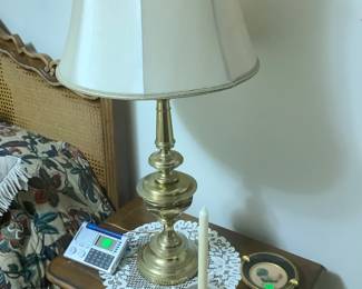 Two stifle brass lamps on matching end tables.