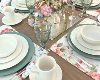 Sitting  inThe middle of the table is an Old Vintage porcelain basket on a piece of glass with flowers.