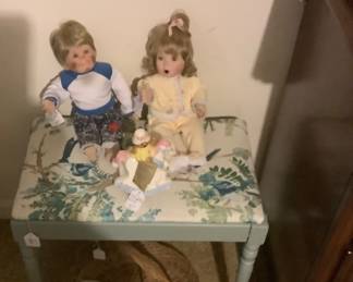Painted and upholestry bench with sweet baby dolls.
