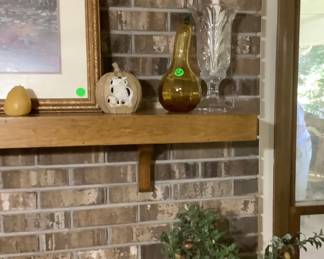 One end of the mantel with a few Halloween or fall items with the beautiful hurricane candle holders.