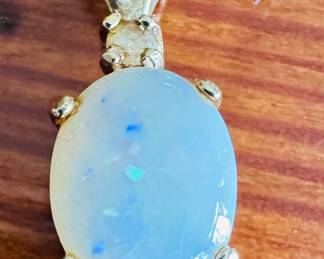 Opal and diamond pendant set in 14 karat gold
