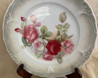 Vintage hand-painted porcelain plate features a beautiful four rose design and beaded edge.  7 3/8" wide.