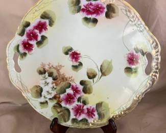 A vintage floral art plate with a gold beaded edge. 10" wide.