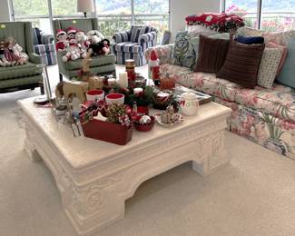 The coffee table you see is supporting more holiday decorations, with still more on the green chairs in the background. If you were looking for a decorative pillow, come check out what we've got.